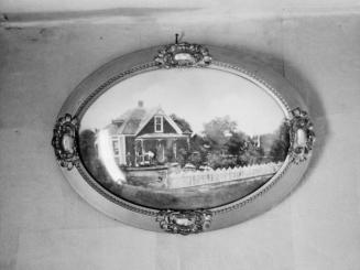 Picture of Jean Norris’ old farm home in Oklahoma, hanging in the Norris living room