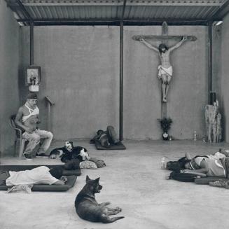 Central American migrants rest in the makeshift chapel of the Hermanos en el Camino migrant shelter. Ixtepec, Oaxaca.