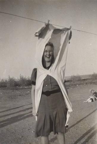 [woman standing wearing clothes on clothesline]