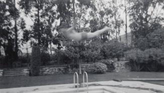 [man diving into pool]