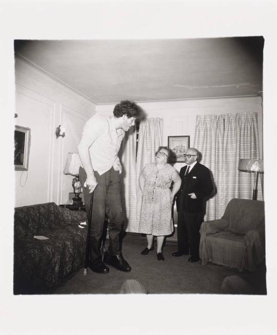 A Jewish giant at home with his parents in the Bronx, N.Y. 1970