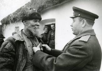 Guards major-general is awarding old patriot with the medal "Service in Battle" Ukraine