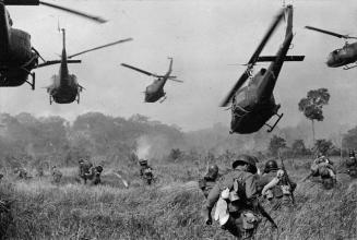 Hovering U.S. Army helicopters pour machine gun fire into tree line to cover the advance of South Vietnamese ground troops in an attack on a Viet Cong camp 18 miles north of Tay Ninh, Vietnam.