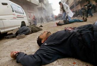 Unidentified bodies lie on a street in Jabalya, the largest refugee camp in the Gaza Strip. Israeli tanks spearheaded a major raid on the camp in the night of March 5, after a suicide bomber had killed 15 people on a bus in Haifa, Israel the day before.