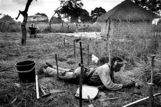 Muxito Sambo carefully uncovers a PPM2 anti-personnel mine in Jika Bairro, Luau, Angola