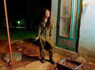 Dana, a sniper instructor, smoking outside her room, Kibbutz Kfar Ha Nassi, Israel