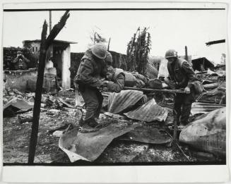 Corpsman moving injured man to the rear of Delta Company, Hue