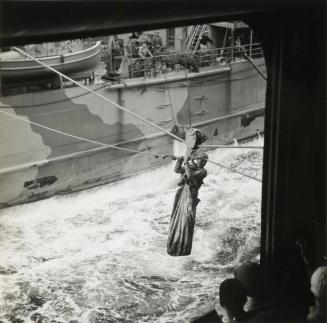 Lt. Commander J.T. Blackburn, after spending sixty-four hours in the Atlantic waiting for rescue, is hoisted from a tanker to the USS SANTEE