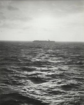 A carrier silhouetted against the Atlantic horizon, en route to North Africa to take part in the Operation Torch landings in Morocco