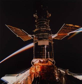 Hubble Space Telescope with panels extended in the payload bay of Endeavour during HST repair mission.