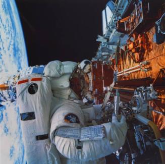 Kathryn C. Thornton works with equipment associated with servicing chores on the Hubble Space Telescope