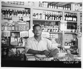 Proprietor of a Small General Store Which Will Soon Be Evacuated Because it is in an Area to be Taken Over by the Army