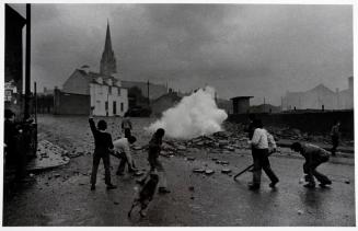 Youths taunting British soldiers who are firing CS gas, the Bogside