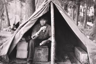 Indian boy in blueberry pickers' camp near Little Fork, Minnesota