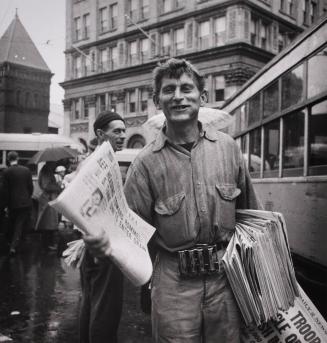 Lancaster, Pennsylvania. Newsman at Center Square on a rainy market day