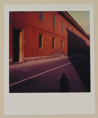 [Exterior of orange building with shadow of photographer]