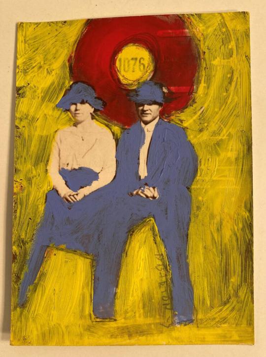 [Couple Seated with Blue Hats]