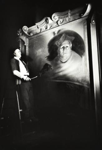 Fellini Touches up a Painting for a Scene in Roma