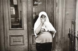 Jeanette with Towel over Head in Front of Door