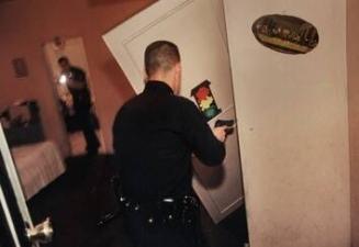 Officers search the apartment of the man shot in his living room, LAPD