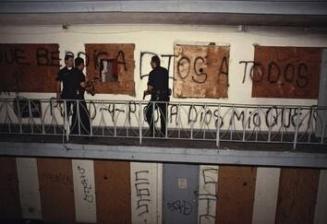 At an abandoned Westlake motel near Skid Row, de facto living quarters for dozens of people without homes, CRASH Unit officers search for a murder suspect, LAPD