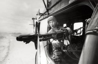 Crew chief Lance Cpl. James C. Farley manning helicopter machine gun of Yankee Papa 13, Vietnam