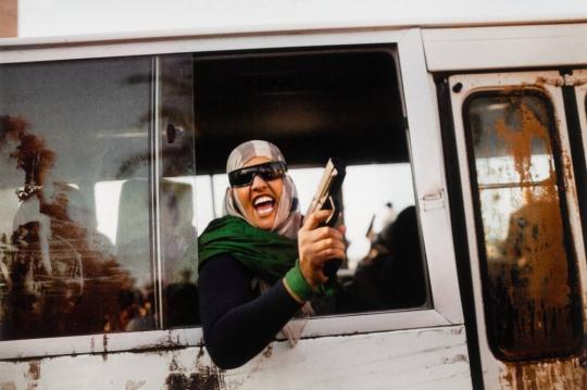 An armed female supporter of colonel Qaddafi chants pro-regime slogans during a demonstration in favor of the Libyan leader in Tripoli’s Green Square, Tripoli, Libya