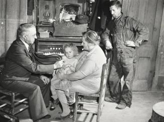 Doctor visits a sick child at home, Scott County, Missouri