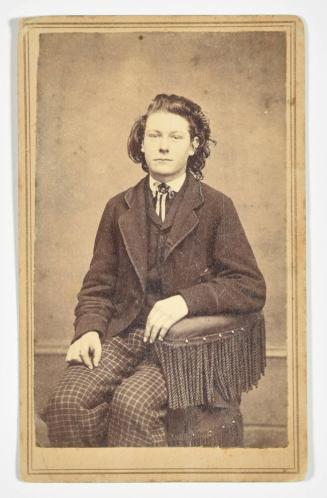 [Boy Seated in a Chair with Fringe]