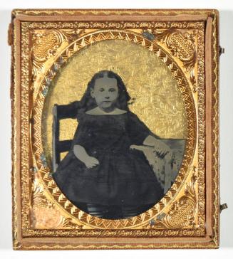 [Young Girl Seated with Hand on Table]
