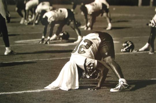 Running Back James Allen and Other Players Stretch after Training Camp Practice