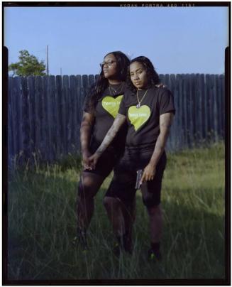 Alisa Coleman, 25, background, embraces Sharise Campbell, 26, after their date at a local gun range.