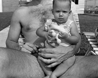 Baby on man’s lap (Father & dgt.) at The Jewish Community Center (JCC) swimming pool