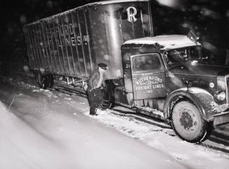 Jim Fletcher Putting on Chains in Order to get the Truck Across the Blue Ridge Mountains of Eastern Tennessee during a Snow Storm