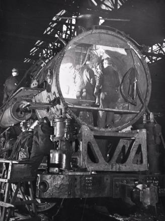 This Former Switching Engine is being Rebuilt for use on the Road, In the Roundhouse at an Illinois Central Railroad Yard, Chicago, Illinois