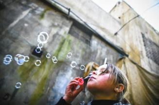 Douma: A young girl blows bubbles.
