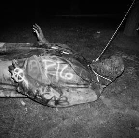 The statue of a Confederate general lies with a noose around his neck after being pulled down on Juneteenth which is celebrated as Emancipation Day