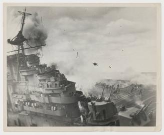 Picture taken at the instant of a high order detonation on port side. Note debris in air and firefighters running to escape. Note topmast broken at radar platform level.