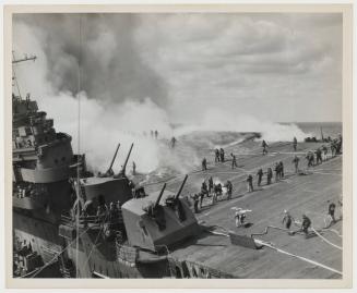 The list of the FRANKLIN affords an unusually clear vision of the extent of the havoc on the flight deck.  Tongues of flames run along the wooden surface as crewmen converge on the endangered area with firehose.  Despite the appalling shock of the explosion, the undamaged guns went into action when the japanese loosed a follow-up aerial attack, and succeeded in driving the few away without sustaining further hits.