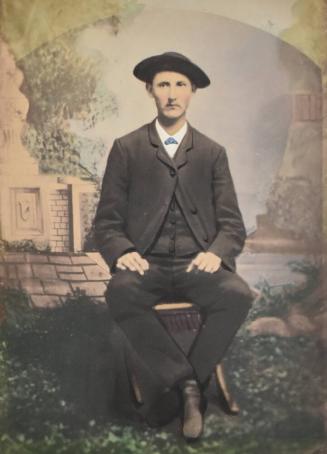 [Seated Man with Hat]
