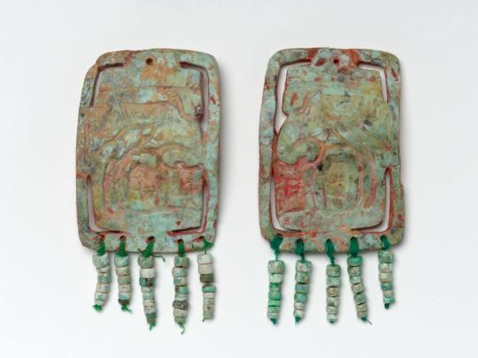 Pair of Ornaments with Faces and Beads