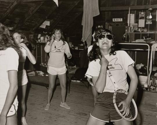 Girl playing tennis racquet guitar at Camp Pinecliffe, Harrison, Maine