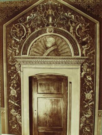 Picolomini Palace. Door decorated with a frieze with various emblems.