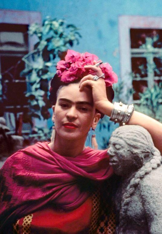 Frida Leaning on a Sculpture by Mardonio Magaña, Coyoacán