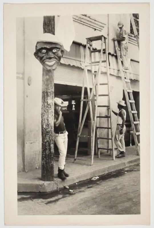 [Men Wearing Hats and Working with Ladders to Decorate a Street]