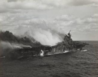 USS FRANKLIN (CV-13) burning after being hit by bombs from Japanese dive bombers: taken from the USS SANTA FE (CL-60)