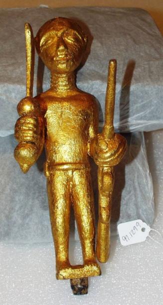Linguist Staff Finial Representing a Man with a Gun and a Sword