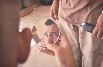 A U.S. soldier with the Lost Platoon, 124th Infantry Regiment, checks out his "high and tight" haircut