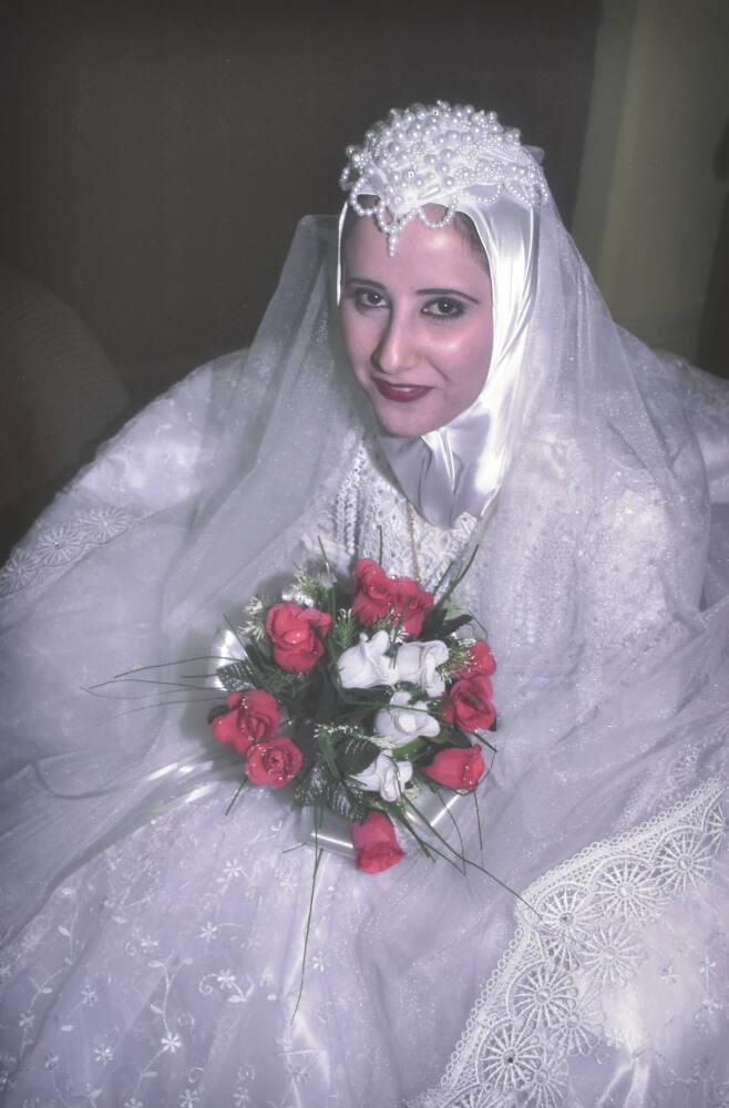 A bride waits for her new husband in the lobby of the Sheraton Hotel, Baghdad