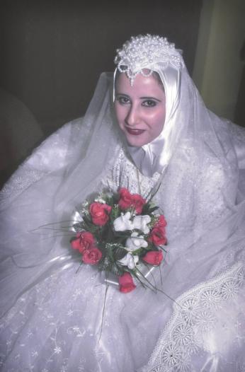 A bride waits for her new husband in the lobby of the Sheraton Hotel, Baghdad
